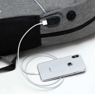 A 3Pcs Et Unisex Laptop Back Pack with an iPhone plugged into it.