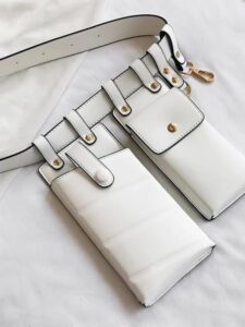 A white Fashion All Match Multifunctional Wallet with two cell phones on it.