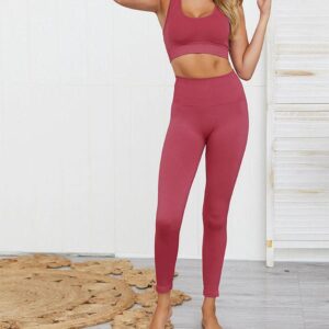 A woman in a pink sports bra and leggings.