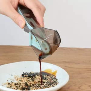 A person pouring Household Measuring Cooking Spoon into a bowl.