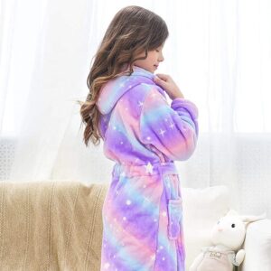 A little girl wearing a purple and blue robe.