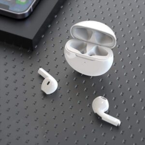 A pair of Pro 6 Earbuds sitting on a table next to a phone.
