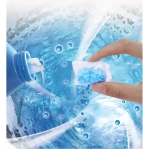 A person is holding a 20Pcs Laundry Scent Beads in front of a washing machine.