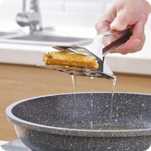 A person pouring oil into a pan with a spatula.