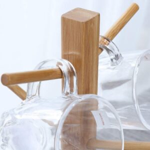A glass cup holder with a Wooden Shelf Drying Rack handle.