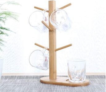 A Wooden Shelf Drying Rack with four glasses and a plant.
