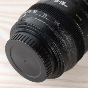 A close up of a 400ml Camera Lens Mug on a wooden table.