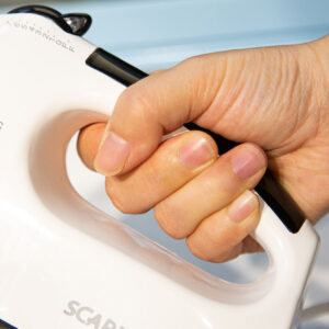 A person's hand holding a Scarlett Hand Mixer Egg Beater 7 Speed Kettle.