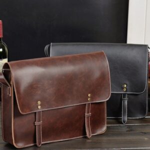 Two Pure Leather Laptop Crossbody Bags on a table next to a bottle of wine.