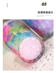 A 500Ml Colorful Cartoon Unicorn Plastic Straw Cup with a rainbow colored liquid in it.