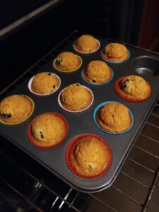 Muffin cupcake silicone baking cups with tray in a muffin tin sitting in the oven.
