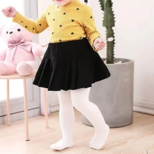 A little girl wearing Solid Color Boy Girl Baby Tights.
