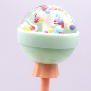 A green Lip Gloss Long Lasting Lip with sprinkles on top.