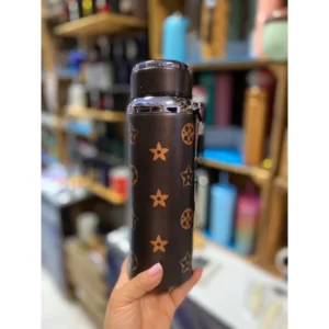 A person holding a water bottle with stars on it.