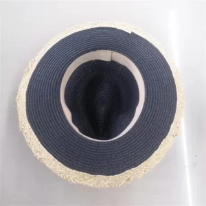A fashion straw Panama sun hat for women on a white surface.