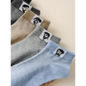 Five pairs of socks with a man's face on them.
