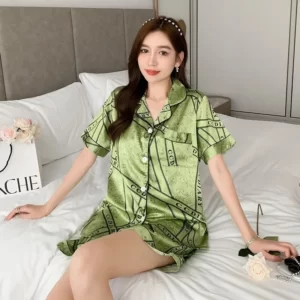 A woman is laying on a bed in a Silk Short-Sleeved Shorts Pajamas Set.