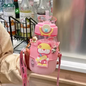 A woman holding a pink bottle with a teddy bear on it.