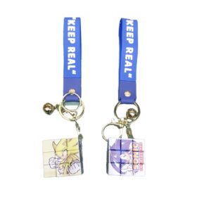 Two Fashion Rubik's Cube Keychains with the words keep real on them.