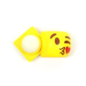 A yellow Emoji Lip Balm on a white surface.