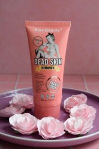 A tube of Kiss Beauty Dead Skin Remover sitting on a pink plate.
