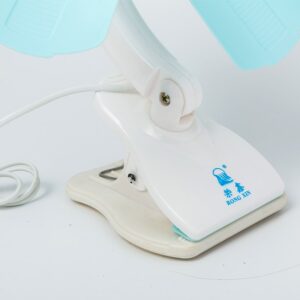 A Mini Clip Electrical Table Fan on top of a surface.