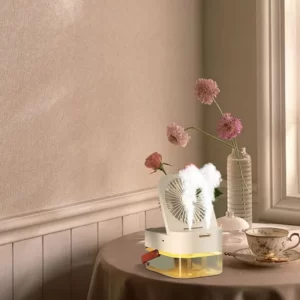 A table with flowers and a Mini Clip Electrical fan on it.