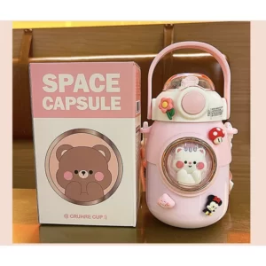 A pink space capsule with a teddy bear inside.