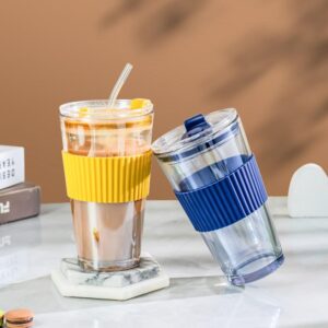 A blue and yellow Water Cup With Lid And With Silica Cover sitting on a table.