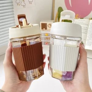 Two people holding up an Anti Scale Silicone Cover Coffee Cup With Straw with a lid.