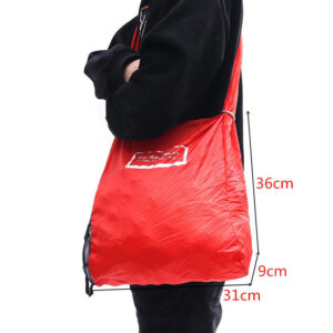 A person holding a Shopping Bag to Roll Up.