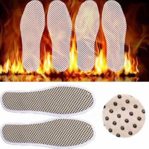 A pair of Tourmaline self heating foot massage insoles with a fire in the background.