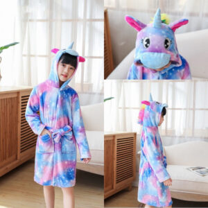 A little girl wearing a unicorn hooded bathrobe.